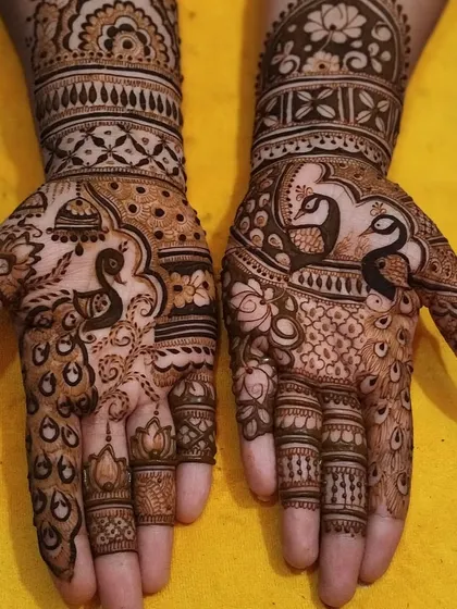 A classic Rajasthani bridal design featuring majestic peacocks and traditional temple dome (jharokha) motifs. This style is known for its full coverage and extremely fine details.