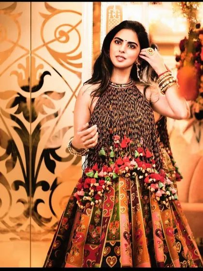 A full-length view of the stunning Torani look, highlighting the intricate floral tassels and the beautifully patterned skirt.