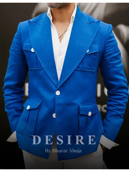 A closer look at the construction of the blue blazer, showing the detailed stitching and functional pocket design. Craftsmanship is at the core of everything I do.