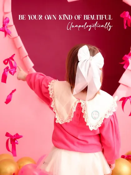 "Be your own kind of beautiful." A thoughtful and artistic shot from the back, focusing on the girl's beautiful white bow and the details of the heart-shaped set.