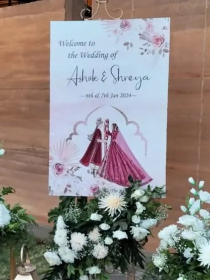 Another view of the couple's caricature welcome sign, a unique and personal touch that guests love.