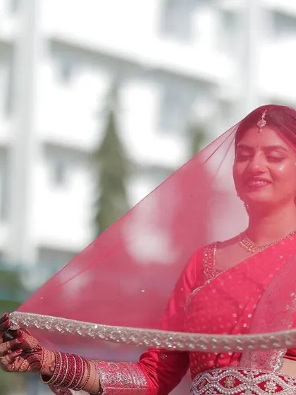 A beautiful shot of the bride with her veil, the dark henna on her hands adding a touch of traditional elegance.