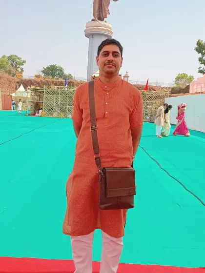 At Ekatmadham in Omkareshwar, in front of the statue of Aadi Guru Shankaracharya Ji.