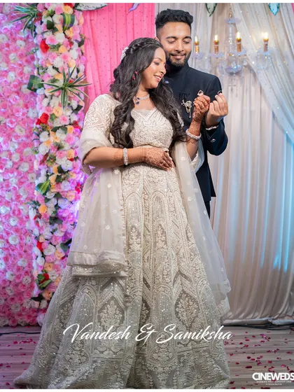 A beautiful photo of the engaged couple, Vandesh and Samiksha, sharing their first dance, with confetti falling around them.