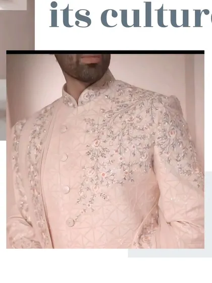 A close-up of the beautiful pastel pink sherwani, showcasing the intricate resham and zardosi work on the collar and front panel.