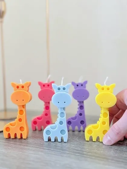 Stand tall and shine bright! These colorful giraffe candles are perfect for a jungle-themed birthday party or baby shower.