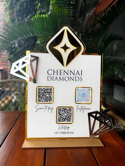 Another angle of the Chennai Diamonds stand, capturing the reflection on the gold accents and the professional layout of the payment and social media QR codes.