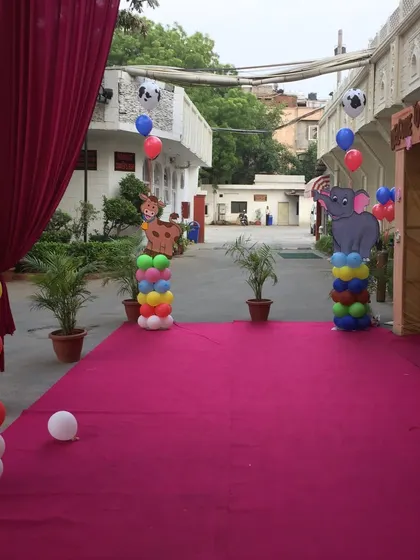 Another take on the jungle theme, with colorful balloon pillars and animal cutouts lining the entrance walkway.