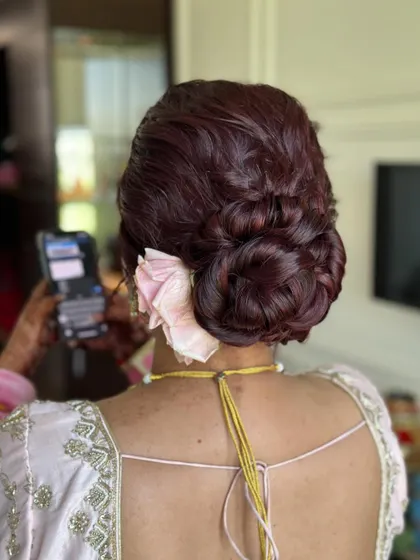 A different perspective of the burgundy bridal bun, showing how the rose is tucked in.