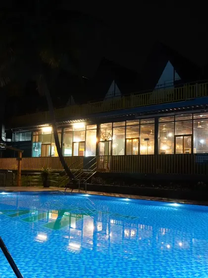 The pool at our Nandi Hills resort beautifully lit up at night, offering a serene and magical ambiance for an evening swim.