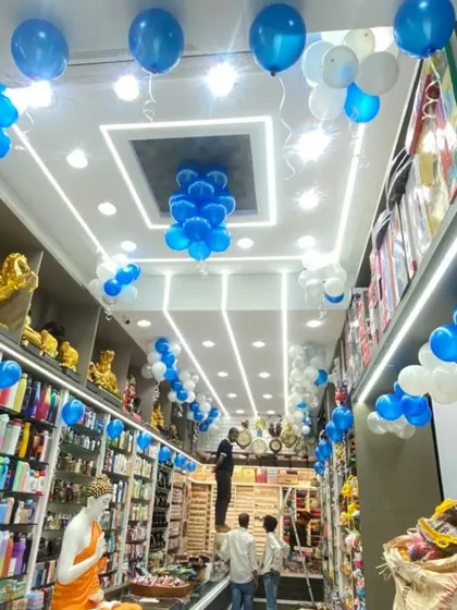 The interior of the "Giftie" shop decorated with blue and white balloon bunches on the ceiling to continue the festive opening theme.