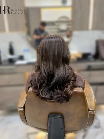The "after" shot, showing a rich, warm brown global color. The hair looks healthy, shiny, and evenly colored.