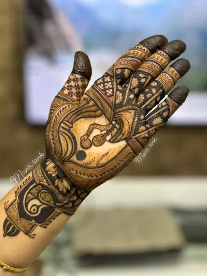 The other hand from the Karwa Chauth set, featuring a decorative kalash (pot) and a peacock motif on the wrist.