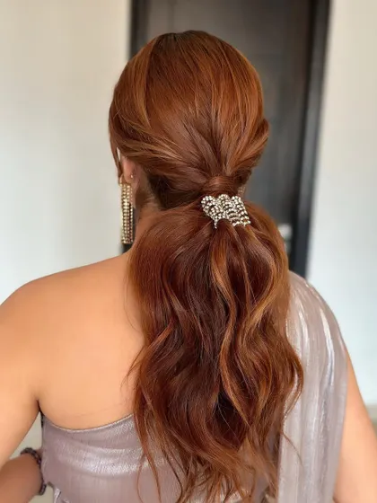 A diamond glam pony for a sparkling cocktail look. The simple, wavy ponytail is elevated with a stunning accessory, and my extensions ensure it has plenty of body.