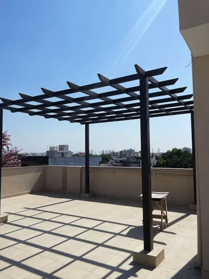 Another view of the bare pergola structure, showcasing the beautiful shadows it casts during the day. This is the blank canvas for a stunning terrace garden.
