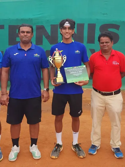 Holding the singles champion trophy at the Super Series event.