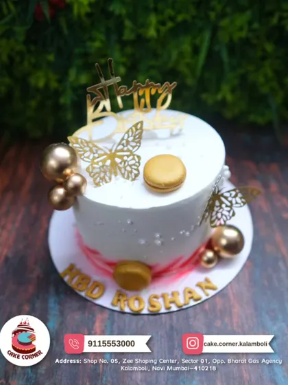 A lovely white cake decorated with golden butterflies and macarons. This small and elegant cake is perfect for an intimate yet stylish birthday celebration for Roshan.
