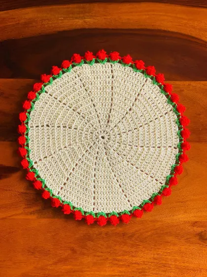 A large cream-colored placemat with a red tulip border, perfect for a single place setting.