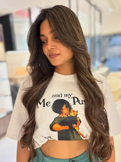 A warm mocha and beige balayage blend paired with long, flowing face-framing layers. This style is perfect for adding shape and dimension to long hair.