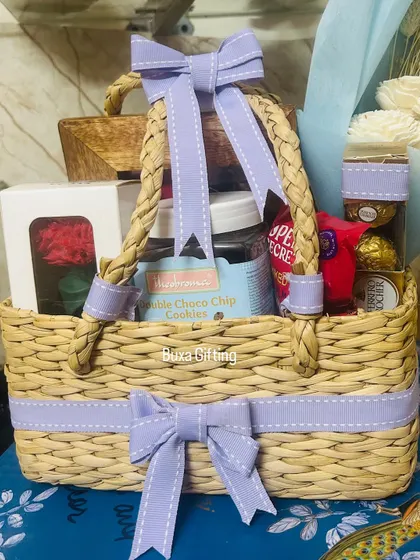 A close-up of the lilac-themed birthday hamper, showing the neatly tied ribbons and the variety of treats inside.