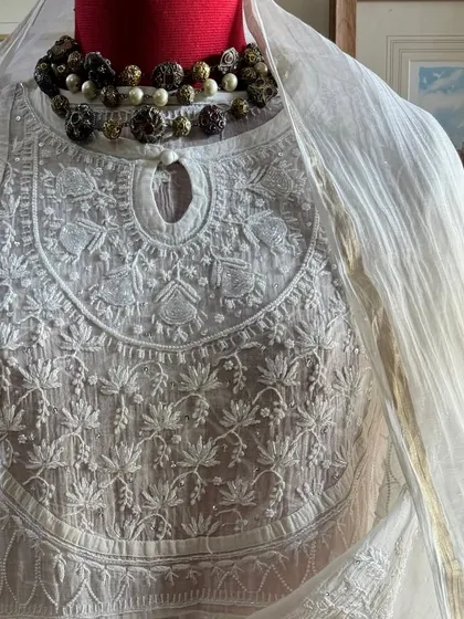 A close-up of the neckline, styled with a statement necklace to illustrate its versatility for festive events.