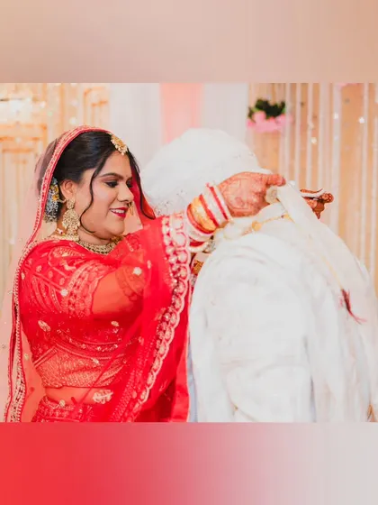 The bride adjusting the groom's attire during the ceremony, a small gesture of care and partnership.
