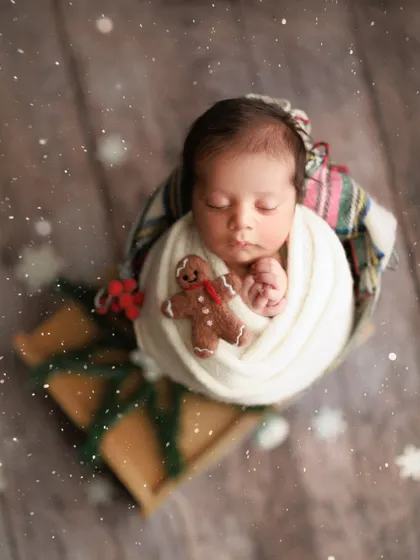 Baby's first Christmas. I love creating festive holiday-themed shots. This little one is wrapped up like a present with a tiny gingerbread man, ready for the most wonderful time of the year.