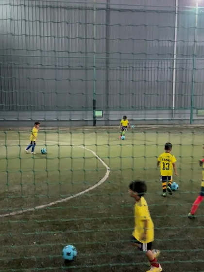 Young players practicing their positioning and ball control during a drill. A good coach ensures that practice is structured and purposeful.