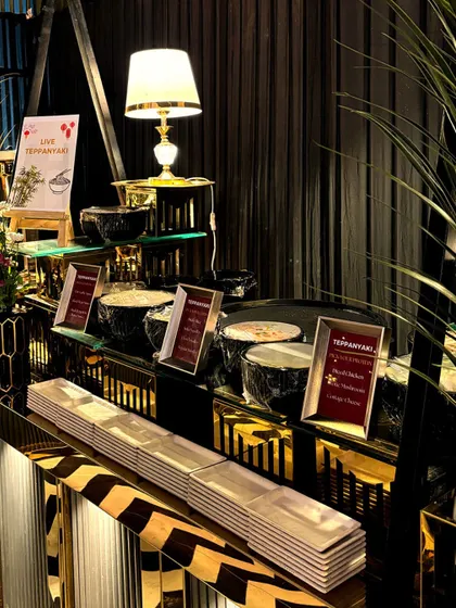 Our live Teppanyaki station, ready for service. The setup includes various ingredients and sauces, allowing guests to customize their dishes, which are then cooked live by our chefs.