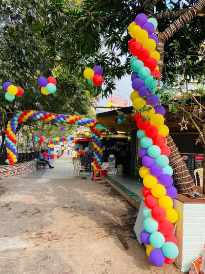 Another view of the extensive outdoor balloon archway, wrapping around trees and creating a festive path.
