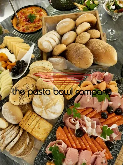 Our modern grazing tables are perfect for networking events. This spread features a curated selection of artisanal breads, imported cheeses, cold cuts, and fresh dips, designed to encourage interaction and conversation.
