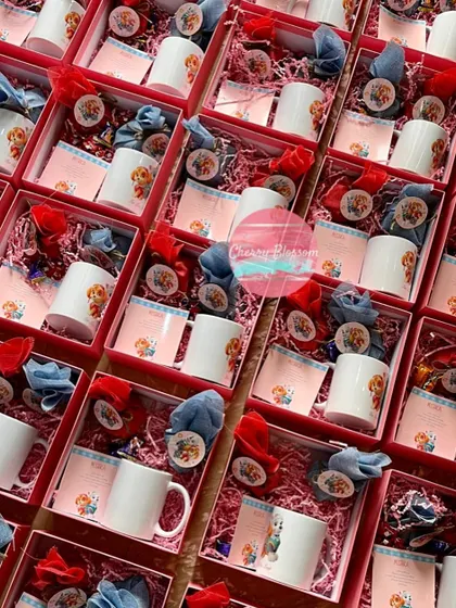 A full view of our Paw Patrol return favours, which we shipped to Kolkata. Each pink box was themed and filled with handmade chocolates, almond rocks, and a customised character mug.