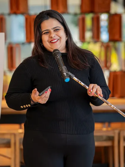 A performer's bright smile shows the joy of being heard. Our community is built on mutual respect and appreciation for every voice that graces our stage.