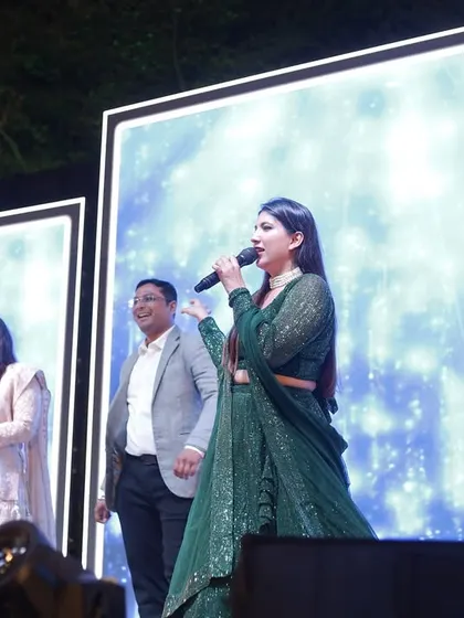 On stage with the happy couple, sharing a laugh. My interactions are always aimed at highlighting their love story.
