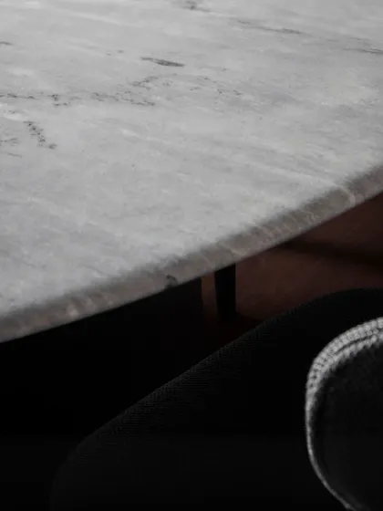 Another detail of the Stealth Marble Table, highlighting the smooth, polished surface that makes it a luxurious centerpiece for any dining room.