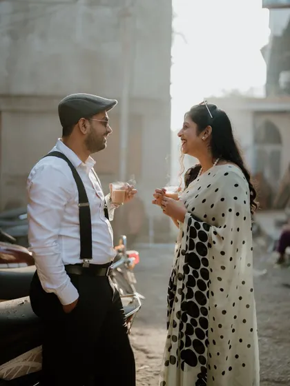 Sometimes the best moments happen over a simple cup of chai. This candid shot from a retro-themed pre-wedding shoot in Pune captures a sweet, everyday kind of love.