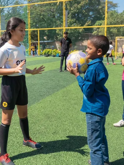 A moment of interaction between an older and younger player at our Annual Day. We foster a sense of mentorship and community across all age groups.