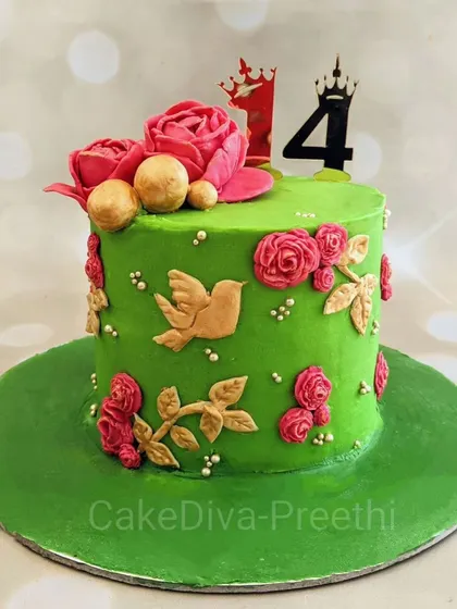 I love how the vibrant colors on this cake came together. The bright green base is adorned with pink and gold fondant roses and a bird, making it a beautiful cake for a 14th birthday.