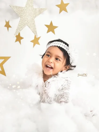 Laughing among the clouds and stars. This dreamy, celestial theme is so magical for a baby girl's photoshoot.
