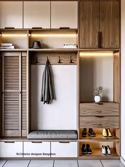 This floor-to-ceiling entryway unit is perfect for maximizing vertical space. It features a louvered cabinet, open shoe shelves with accent lighting, coat hooks, a seating bench, and plenty of overhead storage for a fully functional foyer.