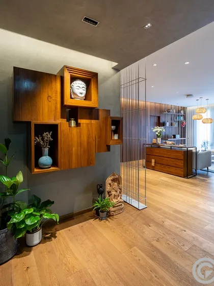 This custom foyer unit is a composition of interlocking wooden boxes, creating a play of solid volumes and open voids for displaying art and artifacts. It serves as a functional and sculptural focal point at the entrance of the home.