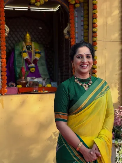 Another serene shot of Madhurani at the temple. The makeup is designed to look flawless both in person and on camera, even in bright outdoor lighting.
