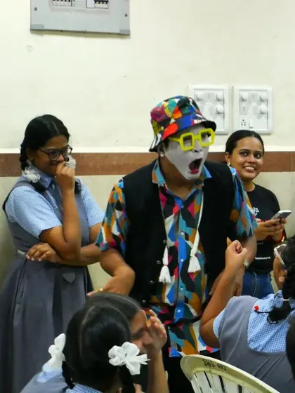 The 'Silent Storyteller' captivates his audience with expressive gestures. The reactions of the children and volunteers show the universal power of a well-told story, even without words.