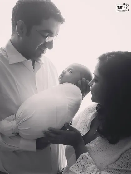 A father's gentle hold. This close up, black and white shot shows the delicate bond between a dad and his newborn baby. You can feel the love in his eyes.