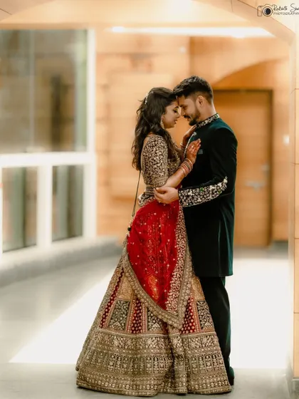 An intimate reception portrait of the couple embracing. The soft lighting and their close pose create a romantic and elegant mood, perfectly capturing their connection.