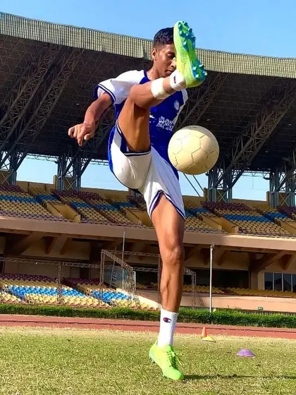 We nurture individual brilliance and skill. This shot captures BPSS player Umesh executing a high kick with perfect form and control during a training session in a professional stadium environment.