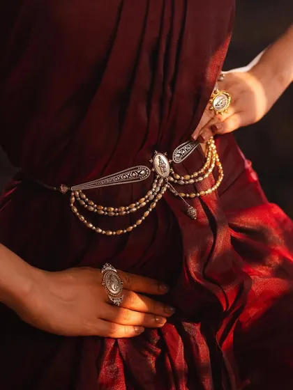 A close-up on a stunning silver and pearl waist belt, or oddiyanam. This highlights my experience in modeling all forms of bridal and traditional Indian jewelry.