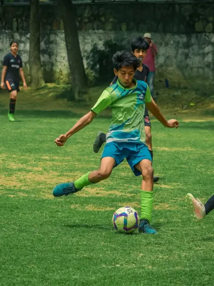 A player shoots the ball, showing great form and power.
