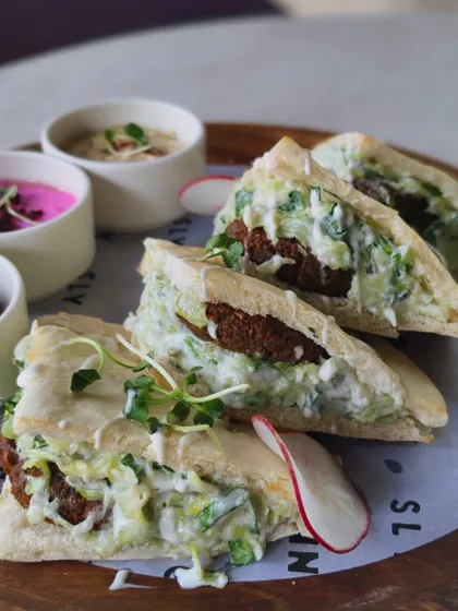Fluffy pita bread filled with falafel and a creamy tzatziki-style sauce. A taste of the Mediterranean.