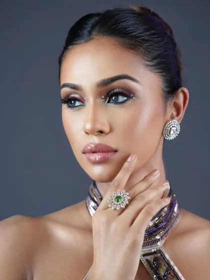 A close-up of the glamorous eye makeup. The use of glitter and sharp lines creates a look that is perfect for a high-fashion or editorial shoot.